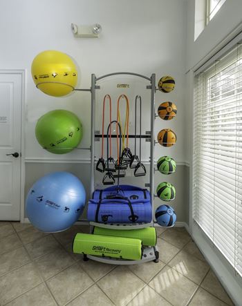 A gym equipment set up in a room.at Sunset Ridge, West Jordan, UT